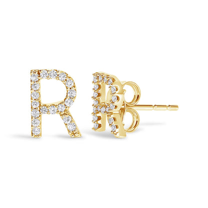 Close-up front and side view of yellow metal stud earrings shaped like the letter R, embellished with round white gemstones in a micro-pave setting.
