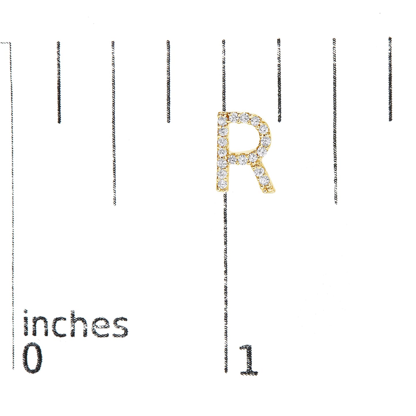 Close-up front view of a yellow round-shaped earring in the form of the letter 'R,' featuring white round gemstones in a micro-pave setting, shown on a scale.