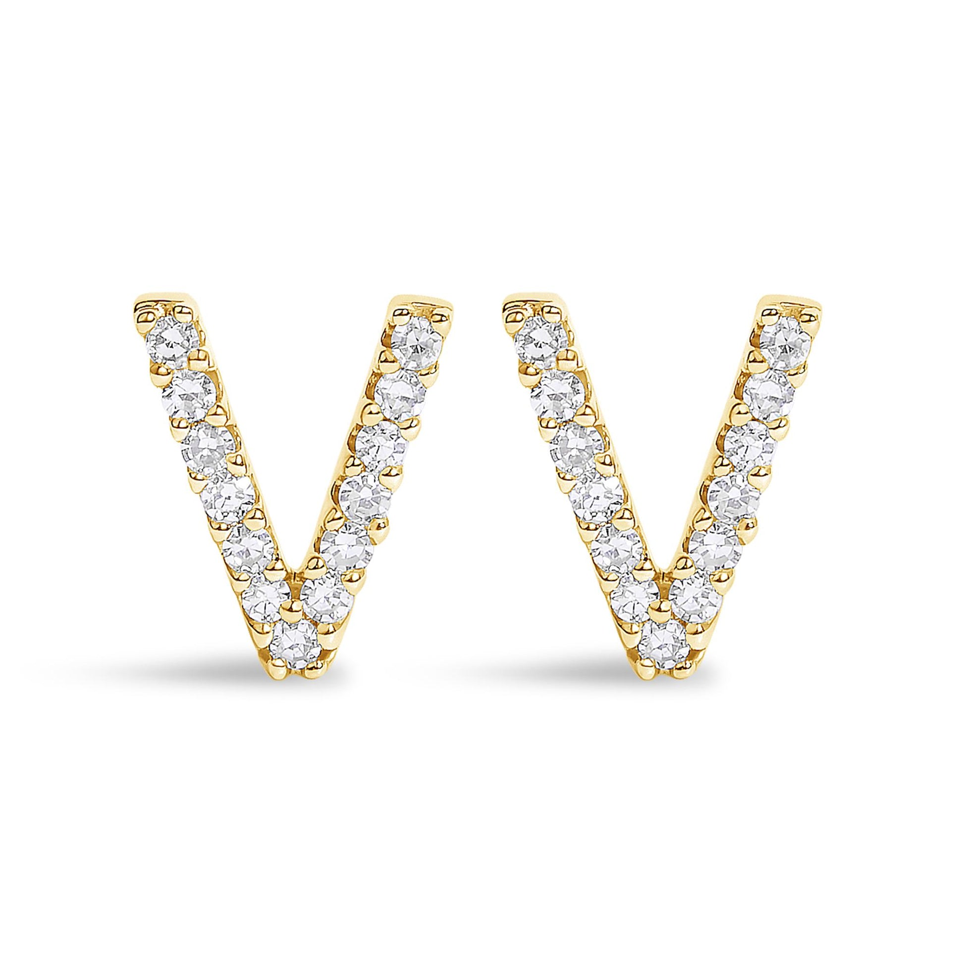Front-facing shot of a pair of yellow metal earrings shaped like the letter V, each adorned with small round white gemstones in a micro-pave setting.