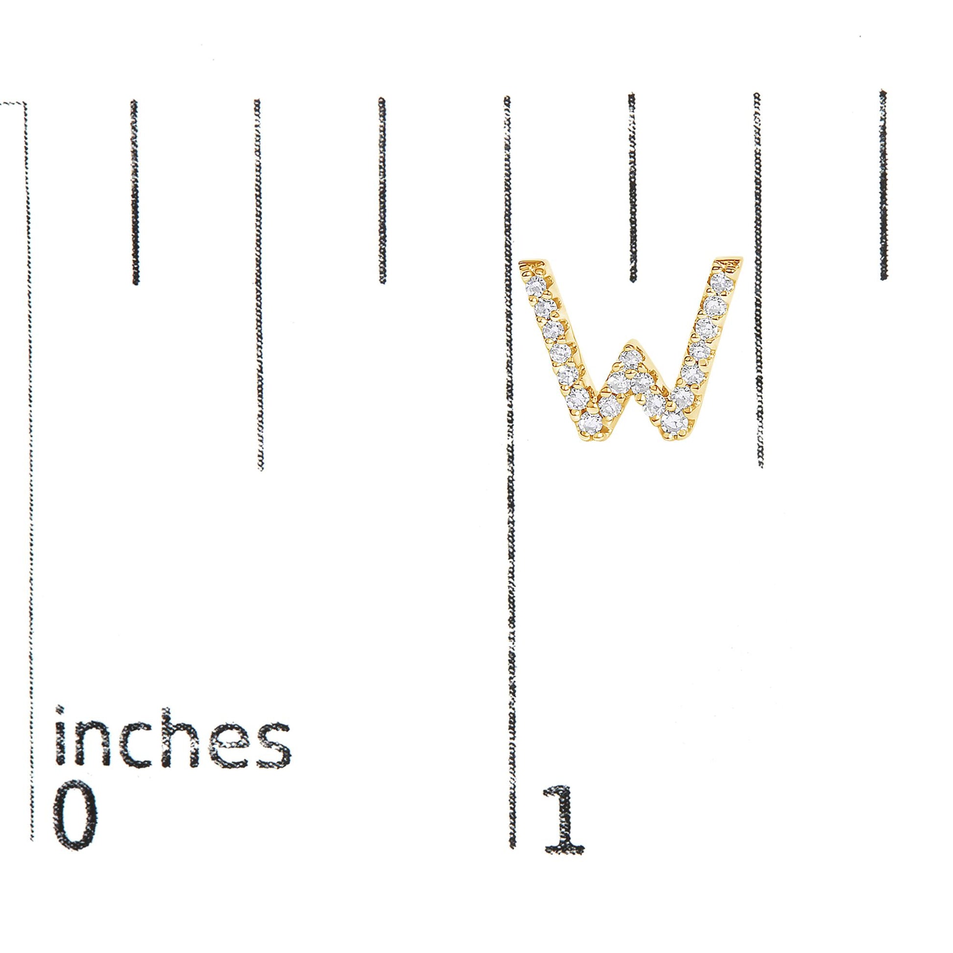 Close-up front view of a yellow metal earring shaped like the letter W, adorned with small round white gemstones in a micro-pave setting, shown on a scale.