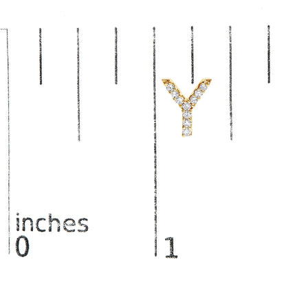 Close-up front view of a yellow metal Y-shaped earring with white round gemstones in micro-pave setting, shown on a measurement scale.