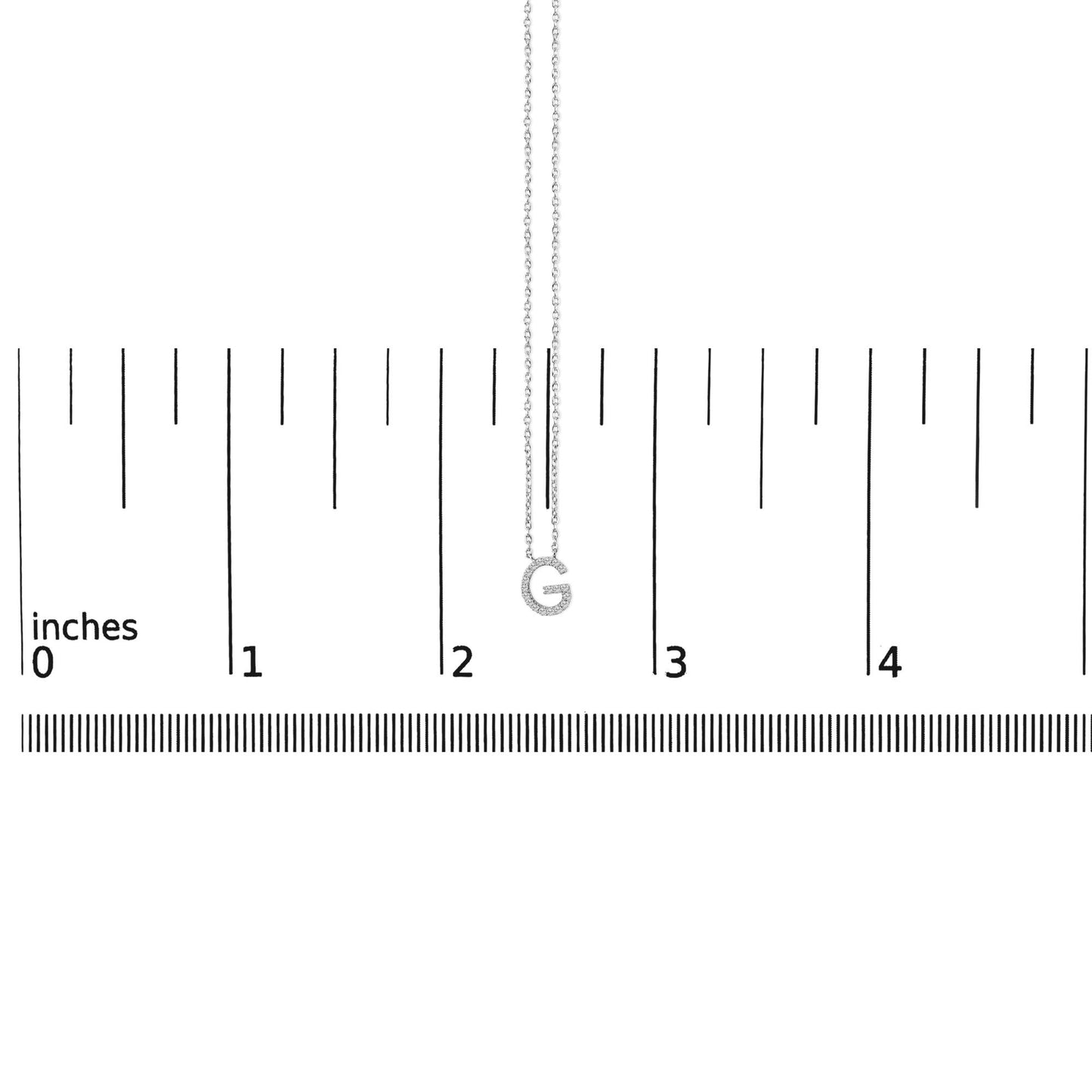 Close-up front view of a white necklace chain with a pendant shaped like the letter G, encrusted with small white gemstones, shown on a ruler scale.