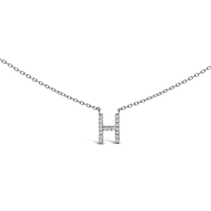 Close-up front view of a white metal necklace with an H-shaped pendant adorned with round white gemstones in a micro-pave setting, shown against a white background.