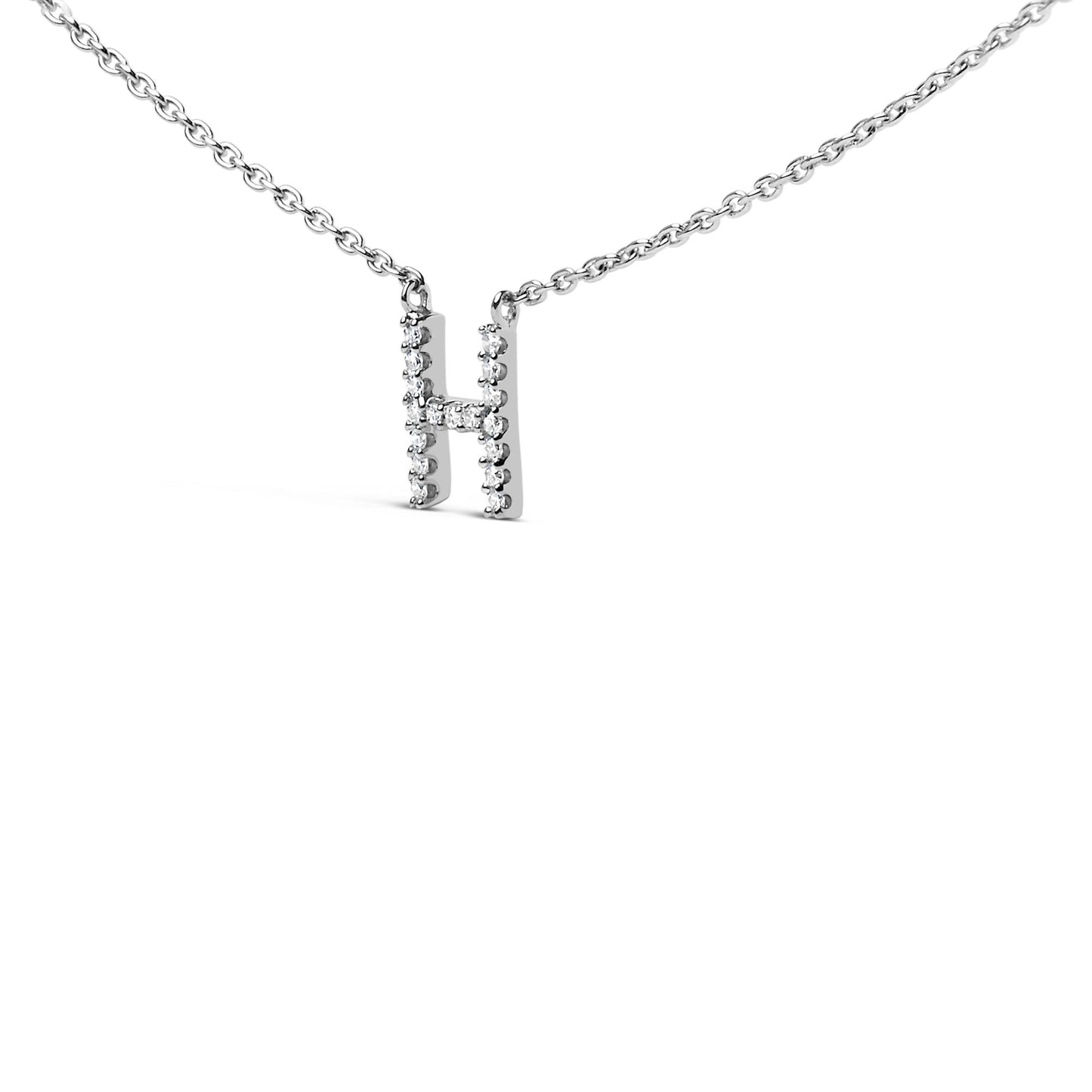 Close-up front angle of a white metal necklace with a pendant shaped like the letter 'H' adorned with round white gemstones in micro-pave setting.