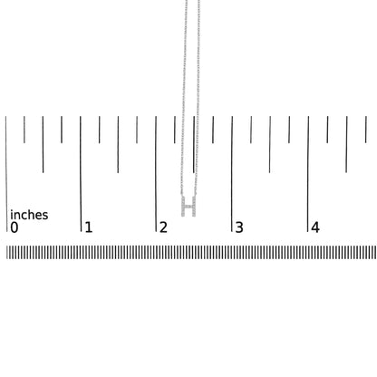 White necklace with an 'H' pendant featuring micro-pave white gemstones, shown flat on a measurement scale, front view.