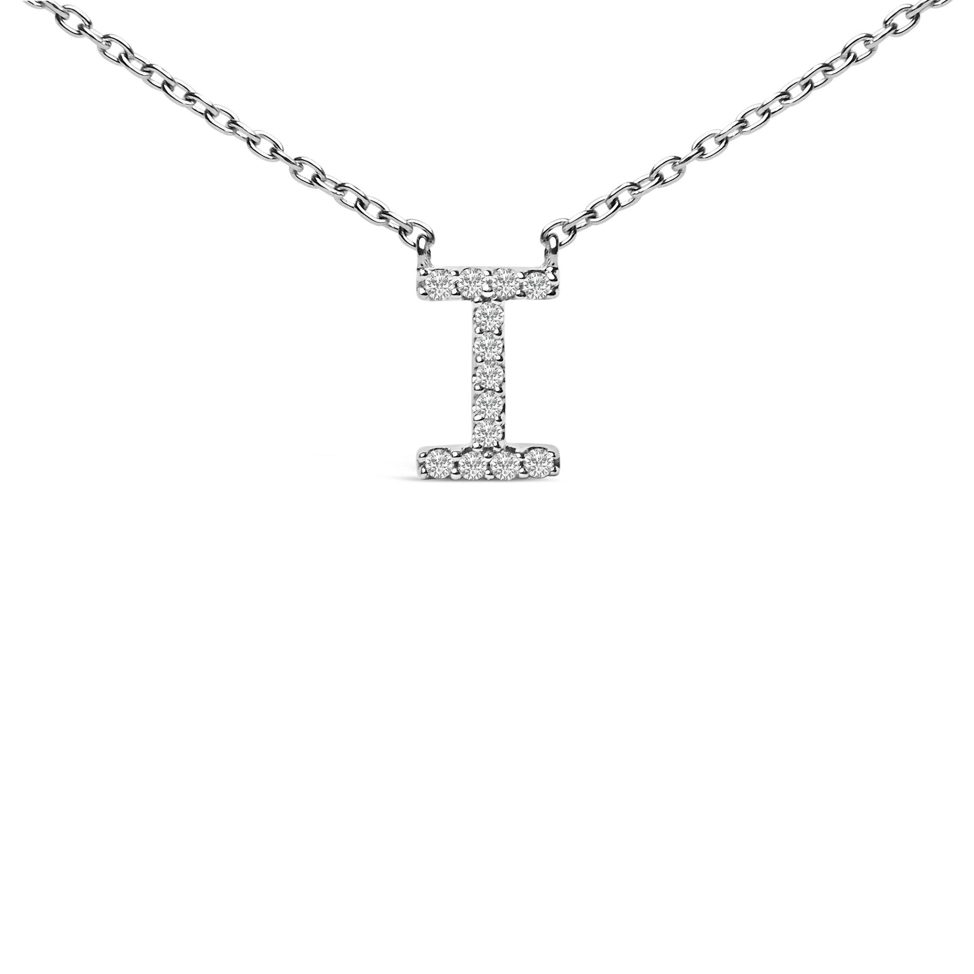 Close-up front view of a white metal necklace with a vertical bar pendant shaped like the letter 'I,' adorned with small round white gemstones in a micro-pave setting along the pendant's surface.