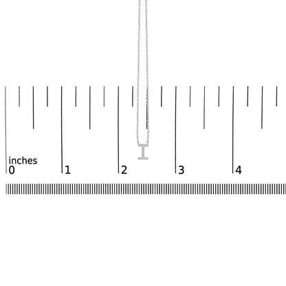 Close-up front view of a white necklace with a micro-pave pendant set with small round white gemstones, shown on a measuring scale.