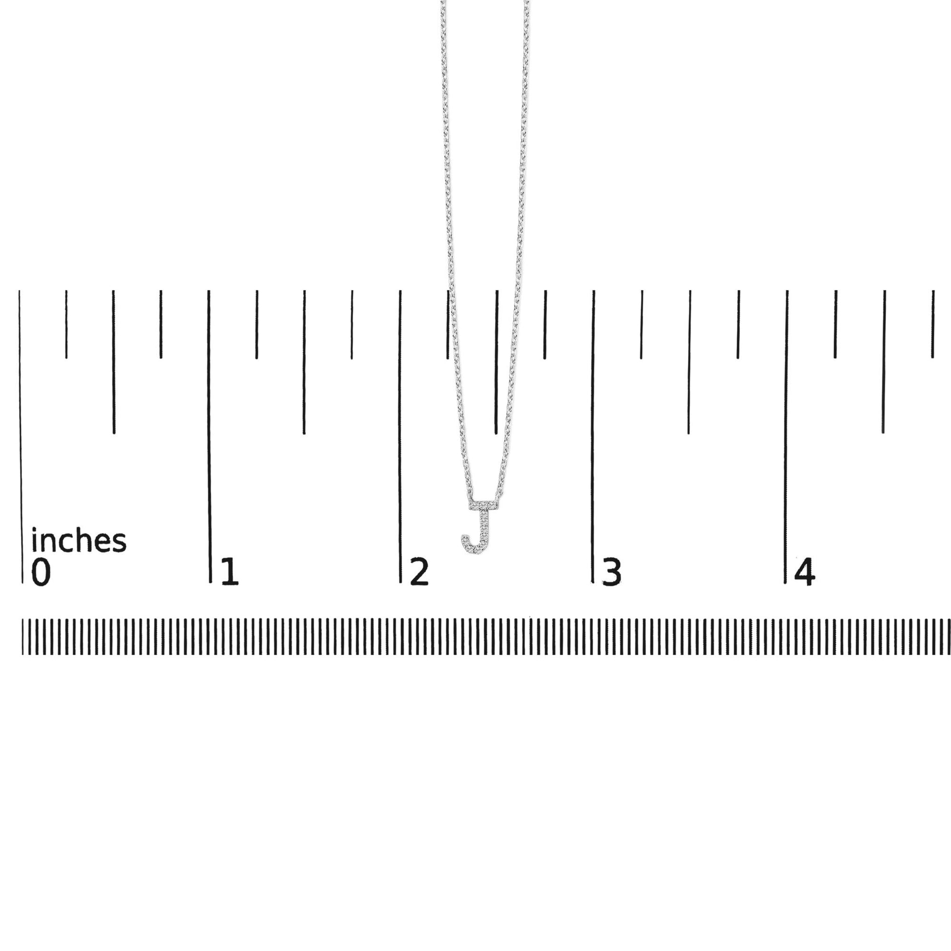 White necklace with a pendant in the shape of the letter J, set with small white gemstones in a micro-pave setting, shown front-facing on a scale.