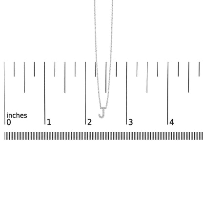 White necklace with a pendant in the shape of the letter J, set with small white gemstones in a micro-pave setting, shown front-facing on a scale.