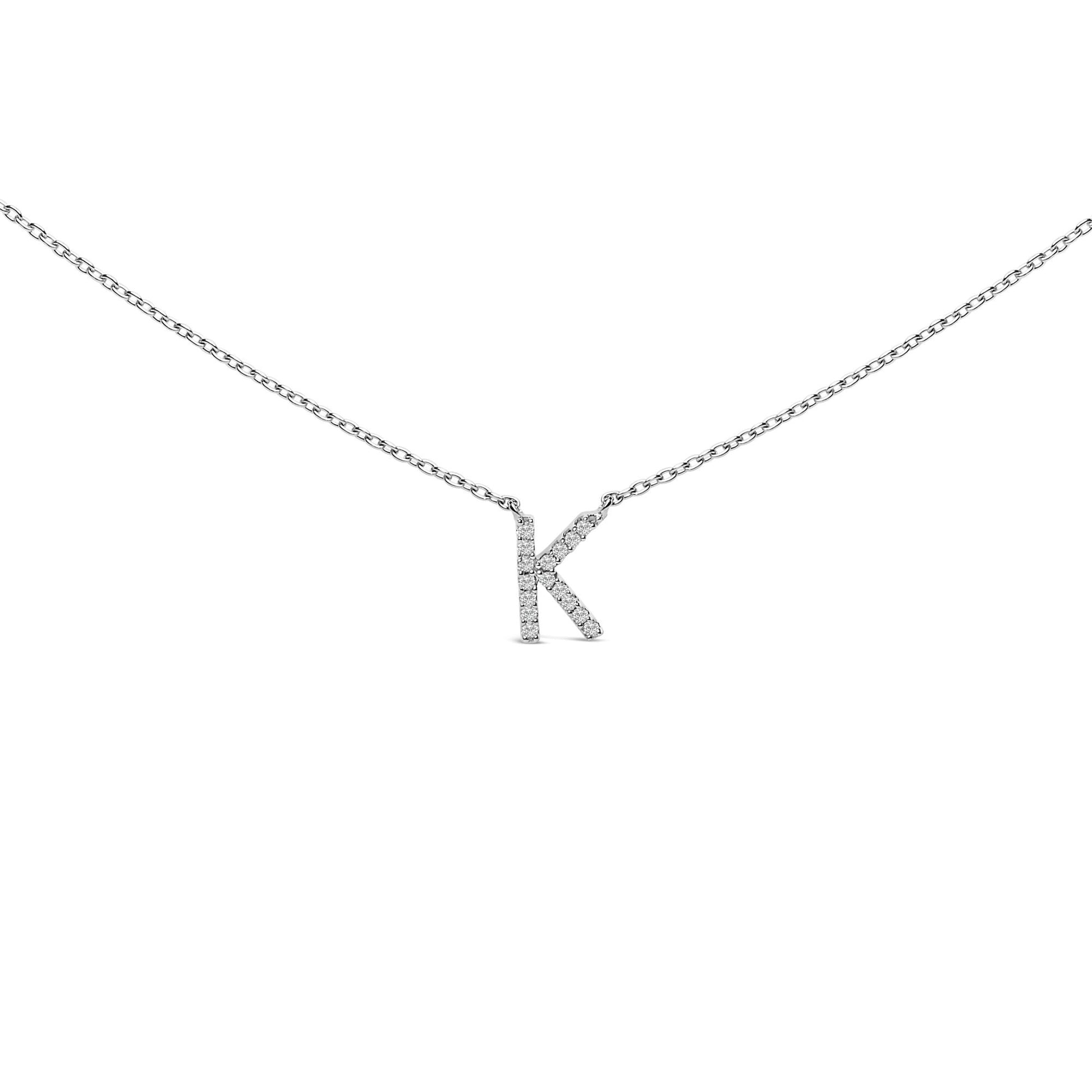 Close-up front view of a white necklace with a pendant shaped like the letter K, featuring round white gemstones in a micro-pave setting, shown against a white background.