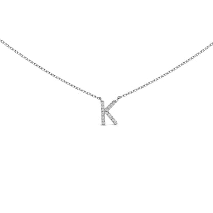 Close-up front view of a white necklace with a pendant shaped like the letter K, featuring round white gemstones in a micro-pave setting, shown against a white background.