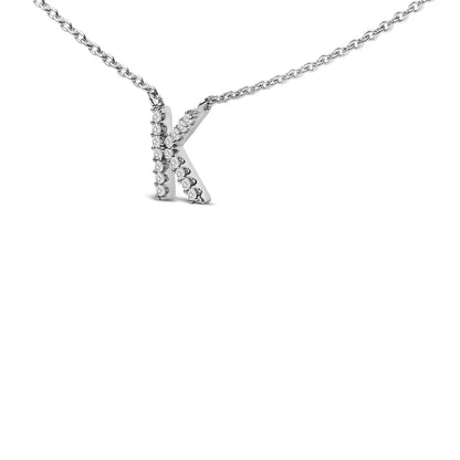 Close-up front angle of a white metal necklace with a pendant in the shape of the letter K, adorned with round white gemstones in a micro-pave setting.