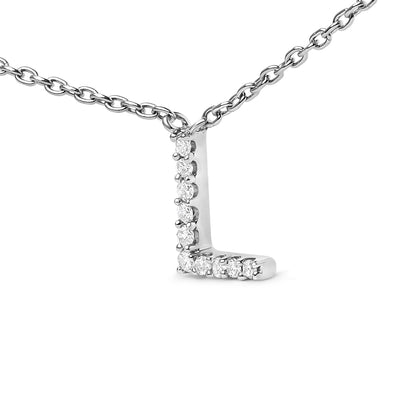 Close-up front angle of a white metal necklace with an L-shaped pendant featuring round white gemstones in a micro-pave setting, shown on a white background.