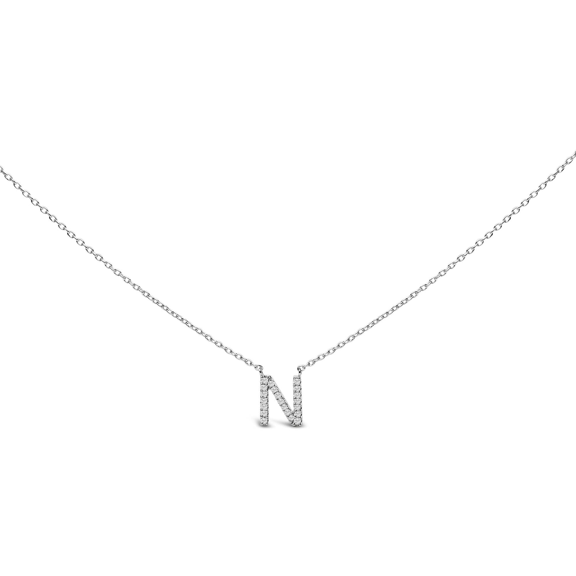 Close-up front view of a white necklace pendant in the shape of the letter 'N' covered with round white gemstones in micro-pave setting, shown against a white background.