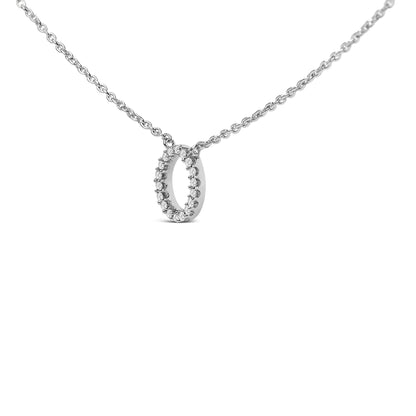 Close-up front view of a white metal necklace with an oval-shaped pendant featuring round white gemstones in a micro-pave setting along the outer edge.