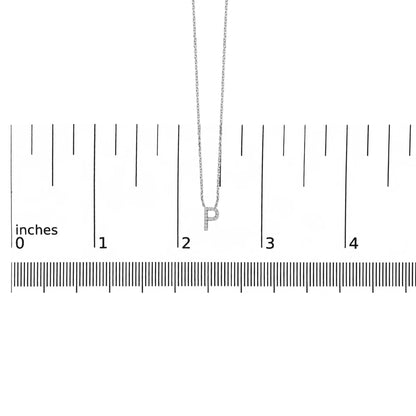 Close-up, front view of a white necklace featuring a pendant shaped like the letter 'P' set with small white round gemstones, shown on a ruler scale.