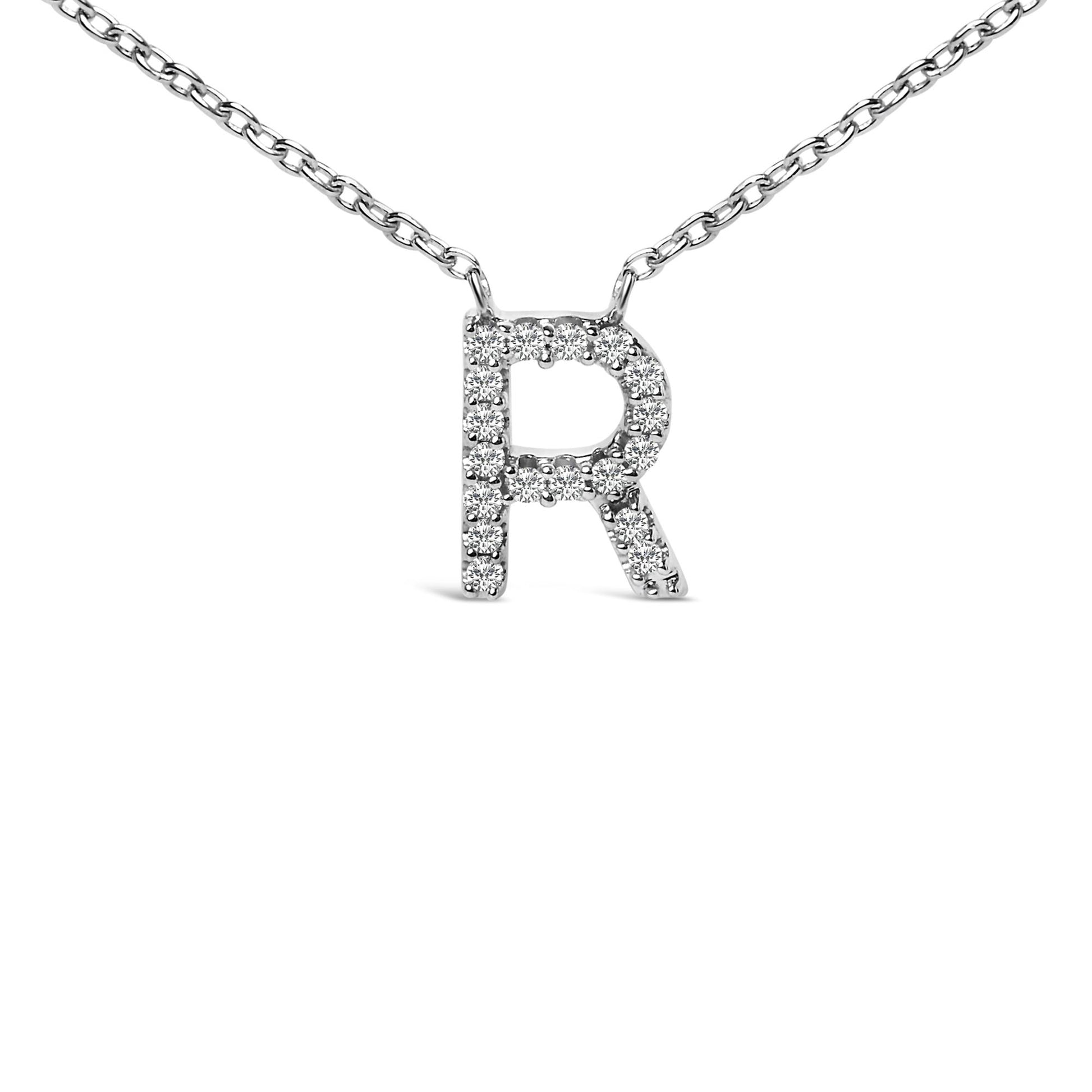 Close-up front view of a white metal necklace with a pendant in the shape of the letter 'R' encrusted with round white gemstones in a micro-pave setting, shown on a white background.