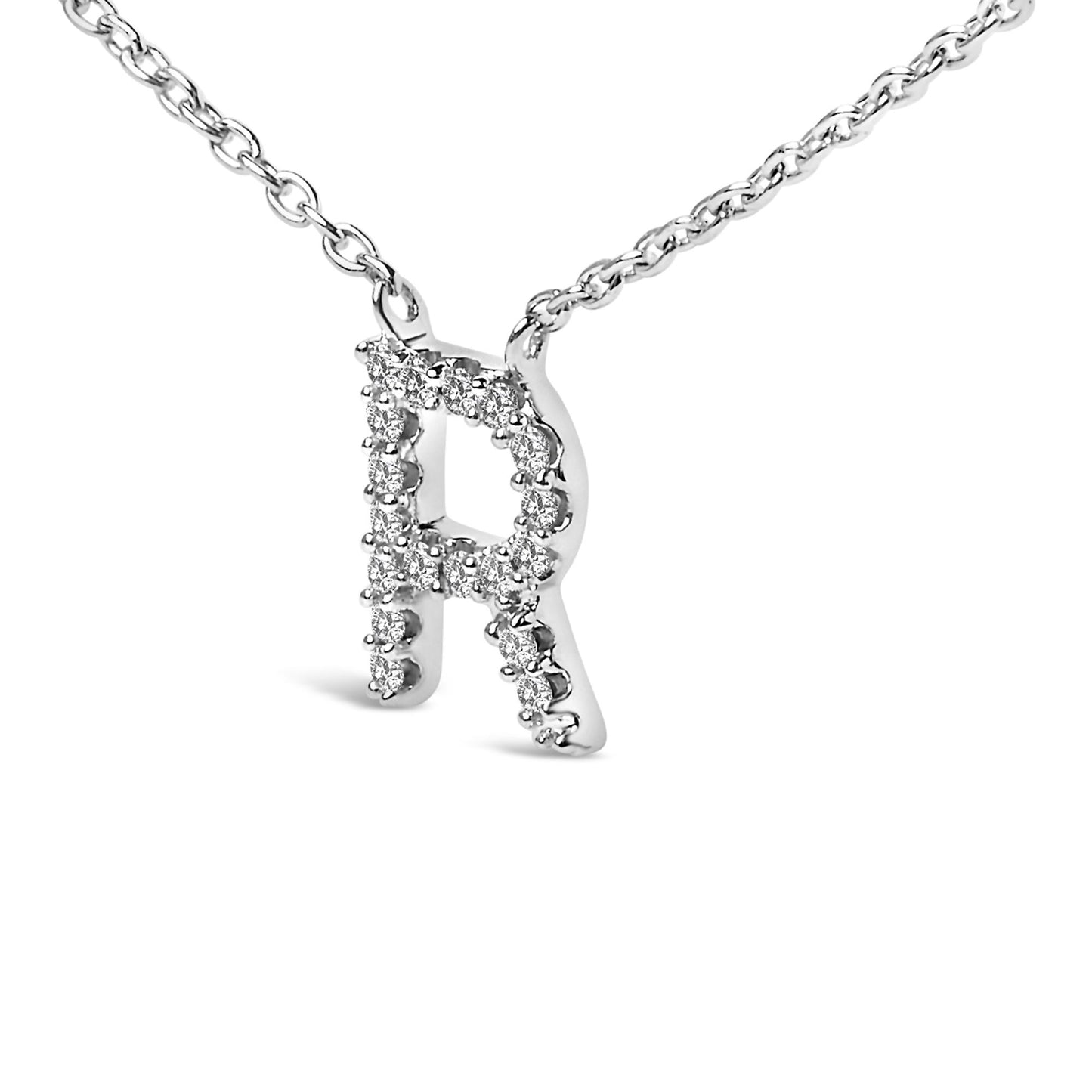 Close-up front angle of a white metal necklace with a pendant in the shape of the letter R, adorned with round white gemstones in a micro-pave setting, shown on a white background.