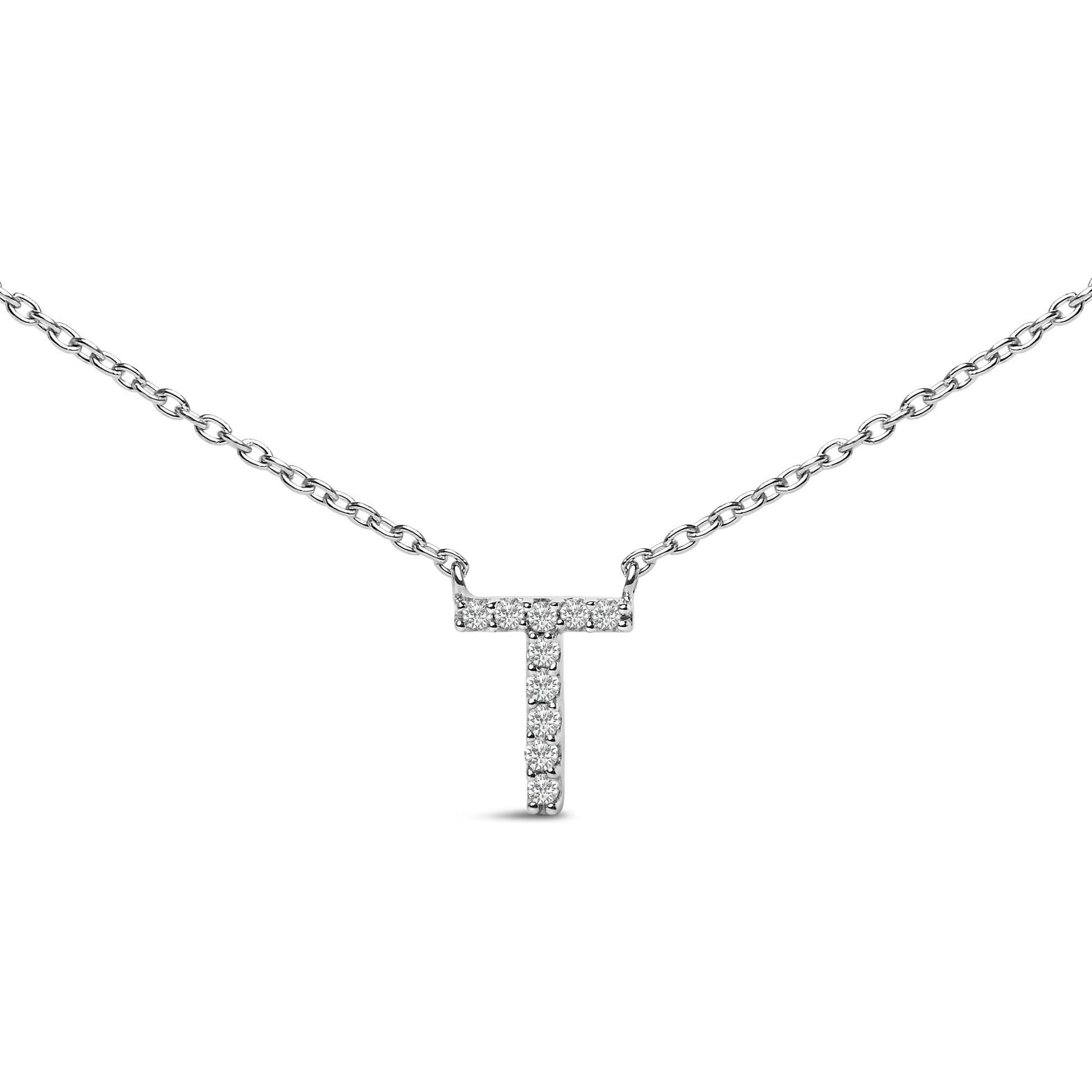 Close-up front view of a white metal necklace with a T-shaped pendant featuring round white gemstones in a micro-pave setting.
