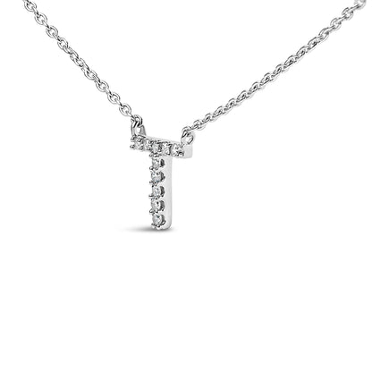 Close-up front view of a white metal necklace with a cross-shaped pendant featuring white round gemstones in a micro-pave setting.