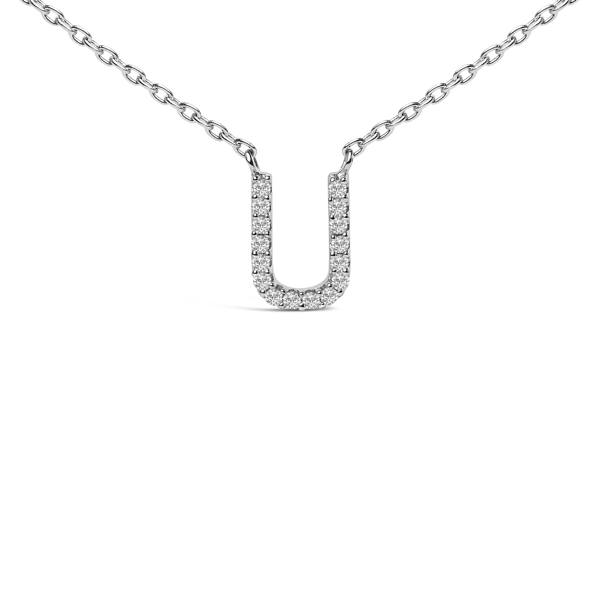 Close-up front angle of a white metal necklace with a U-shaped pendant featuring round white gemstones in a micro-pave setting.