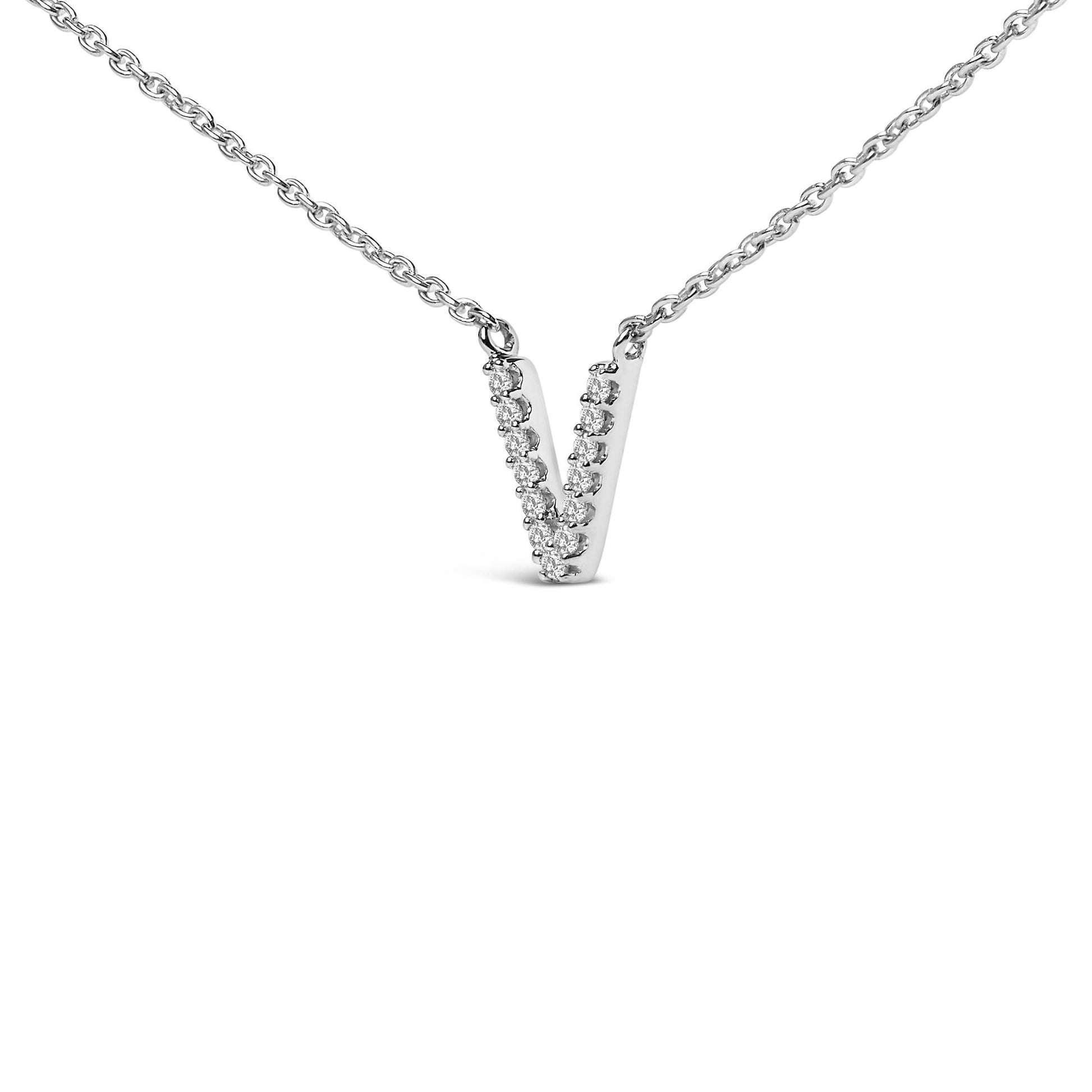 Close-up, front view of a white metal necklace with a V-shaped pendant adorned with small white gemstones in a micro-pave setting.