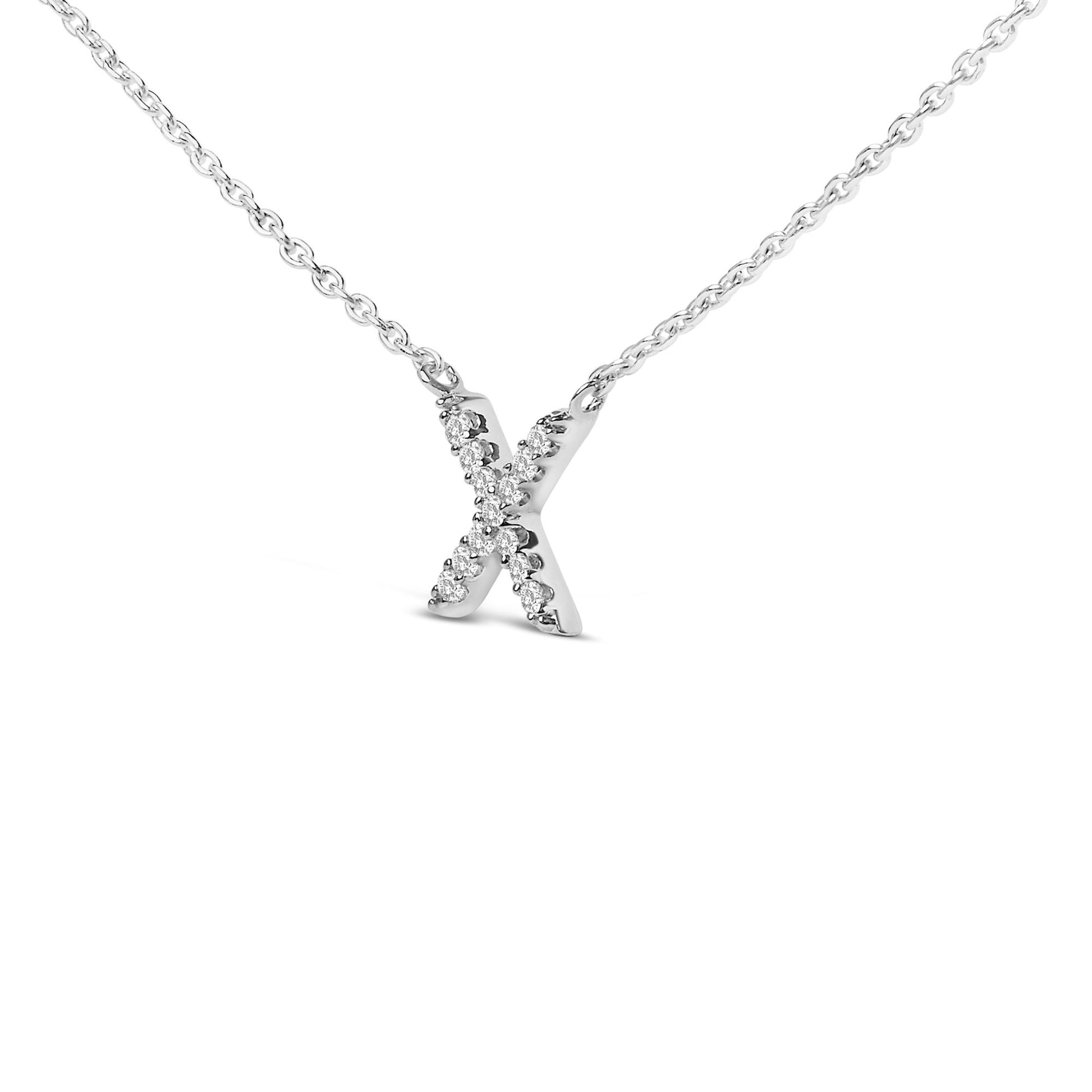 Close-up front view of a white metal necklace featuring an X-shaped pendant adorned with round white gemstones in a micro-pave setting.