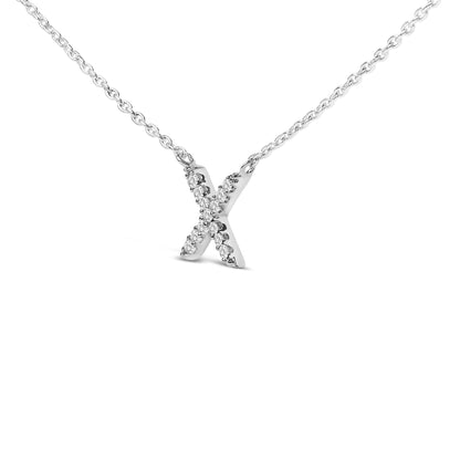 Close-up front view of a white metal necklace featuring an X-shaped pendant adorned with round white gemstones in a micro-pave setting.