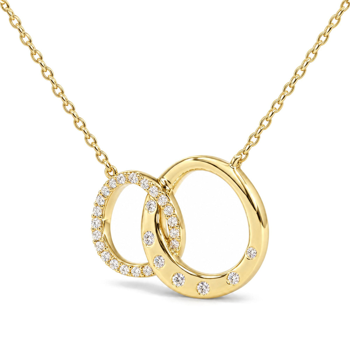Close-up front angle of a yellow necklace featuring two interlocking circular pendants, one fully adorned with small white gemstones in prong settings and the other with scattered white gemstones.