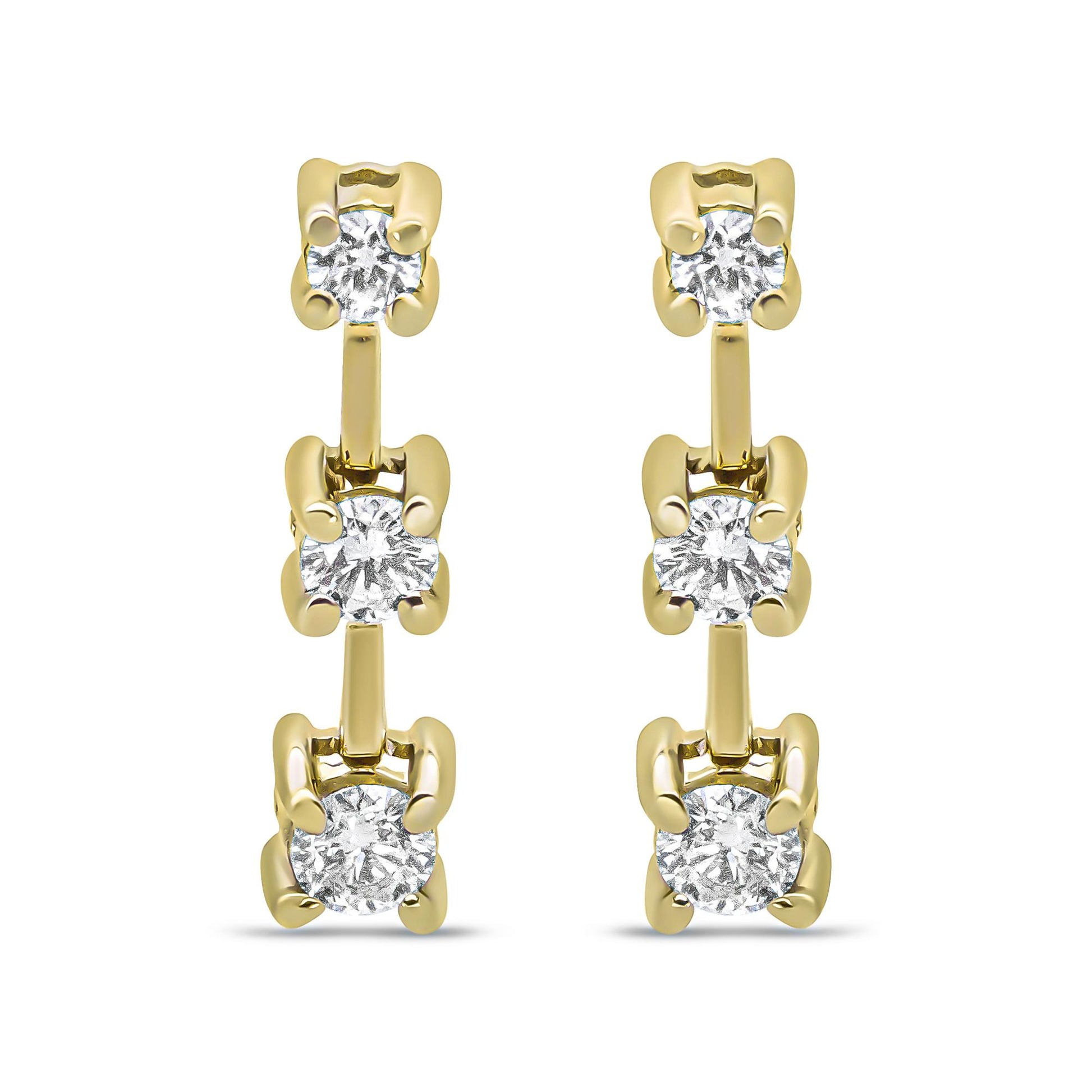 Front-facing view of yellow metal earrings featuring a vertical row of three prong-set white round gemstones.