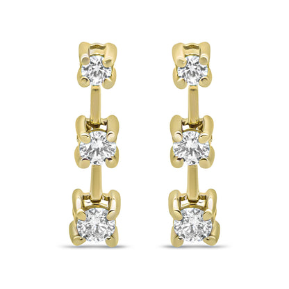 Front-facing view of yellow metal earrings featuring a vertical row of three prong-set white round gemstones.