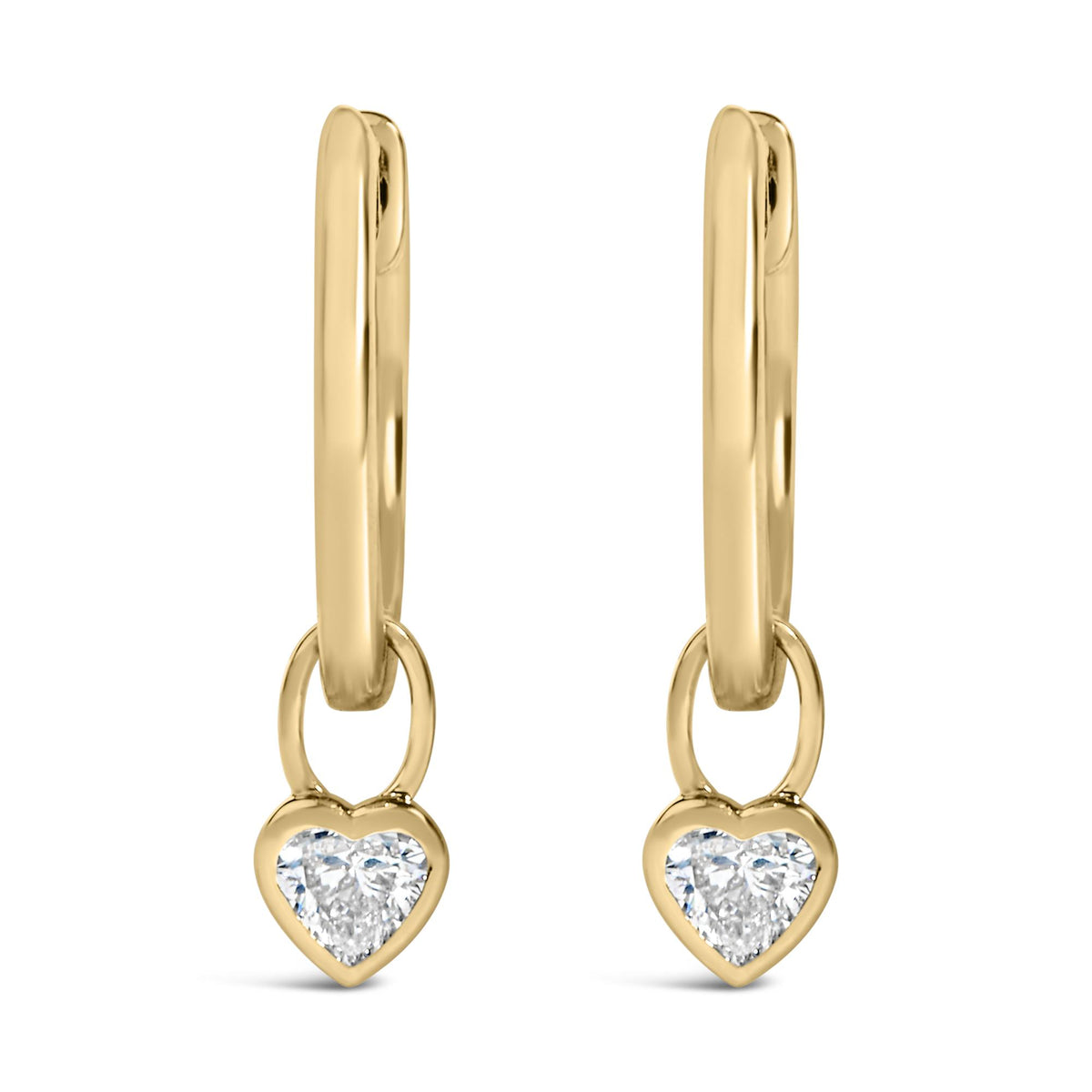 Close-up front view of a pair of yellow metal earrings featuring dangling heart-shaped charms with white gemstones in bezel settings.