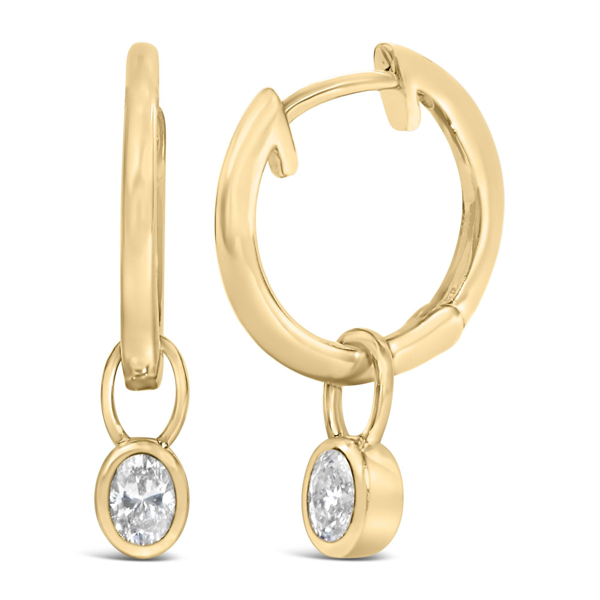 Close-up front angle of yellow metal hoop earrings with oval-shaped white gemstones in a bezel setting hanging from each hoop.