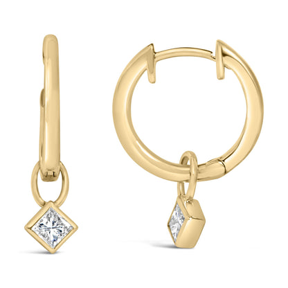 Close-up front and side view of yellow metal hoop earrings with a dangling princess-shaped white gemstone in a bezel setting.