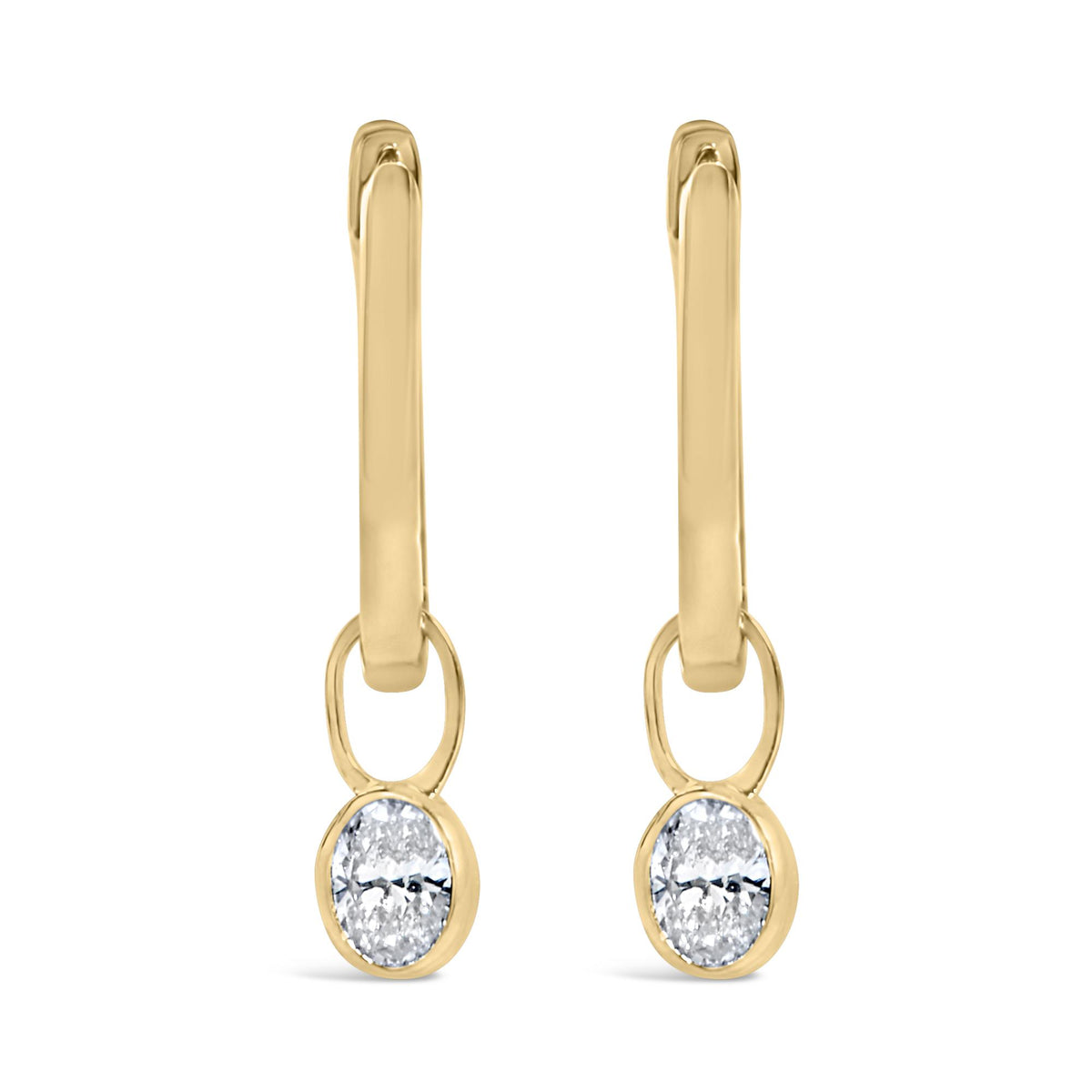 Close-up front view of yellow metal drop earrings with oval-shaped white gemstones in bezel settings at the bottom.