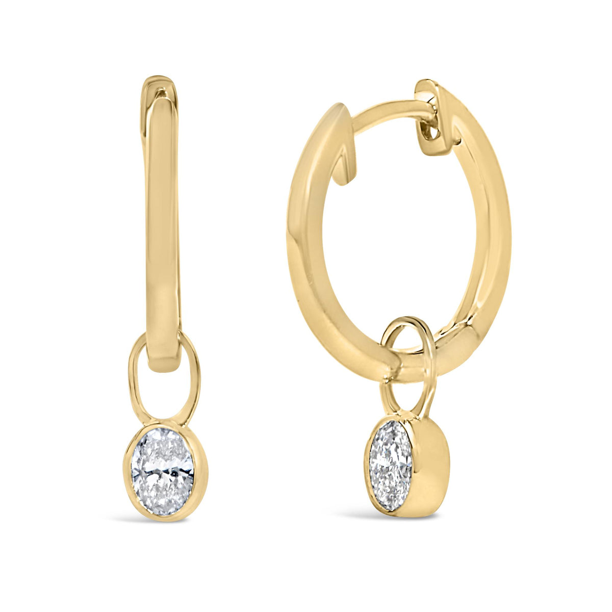 Close-up front and side view of yellow metal hoop earrings with small dangling oval-shaped white gemstones in bezel settings.