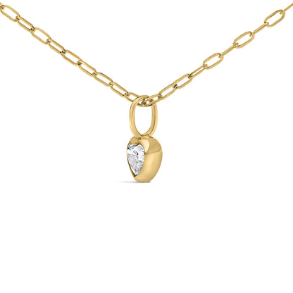 Close-up front view of a yellow necklace chain with a heart-shaped pendant featuring one white gemstone in bezel setting.