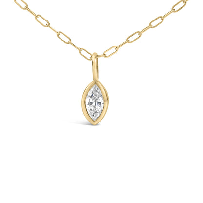 Close-up front view of a yellow metal necklace chain with a bezel-set marquise-shaped white gemstone pendant.