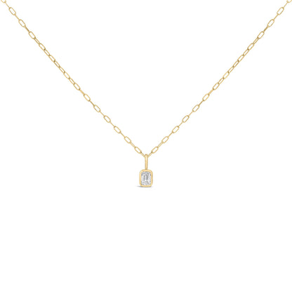 Close-up front view of a yellow necklace with a bezel-set emerald-shaped white gemstone pendant on a chain link.