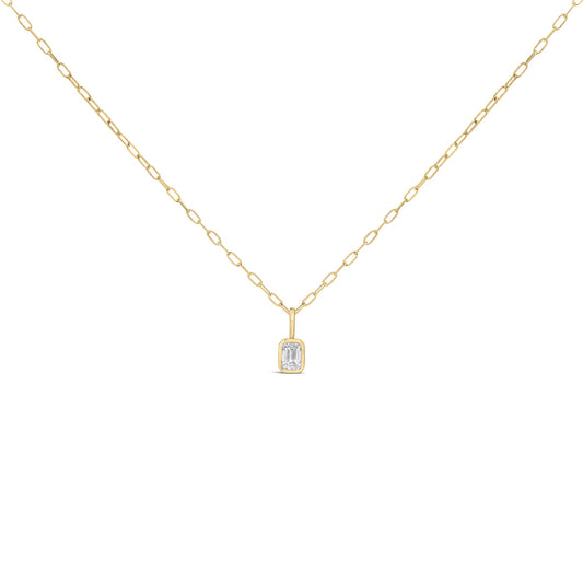 Close-up front view of a yellow necklace with a bezel-set emerald-shaped white gemstone pendant on a chain link.