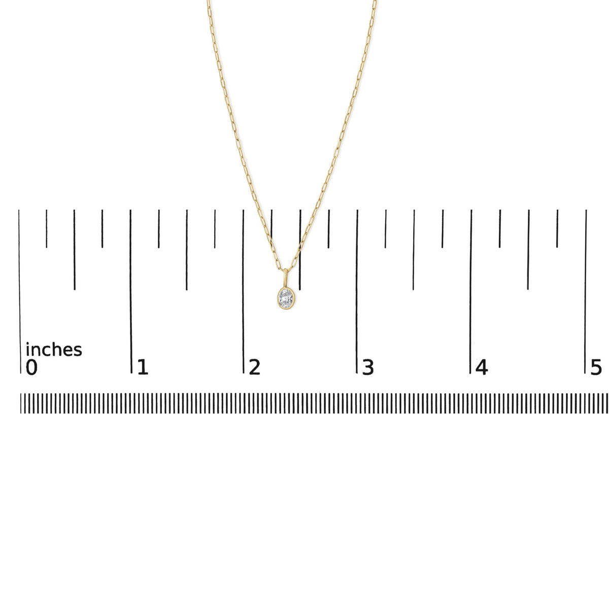 Close-up front view of a yellow necklace with a pendant featuring one oval white gemstone in a bezel setting, shown on a scale.