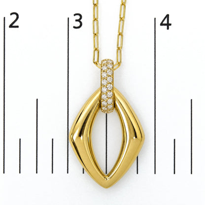 Close-up front view of yellow metal necklace pendant with an elongated diamond-shaped design and a row of round white gemstones set in a prong setting on the bail, shown on a measurement scale.