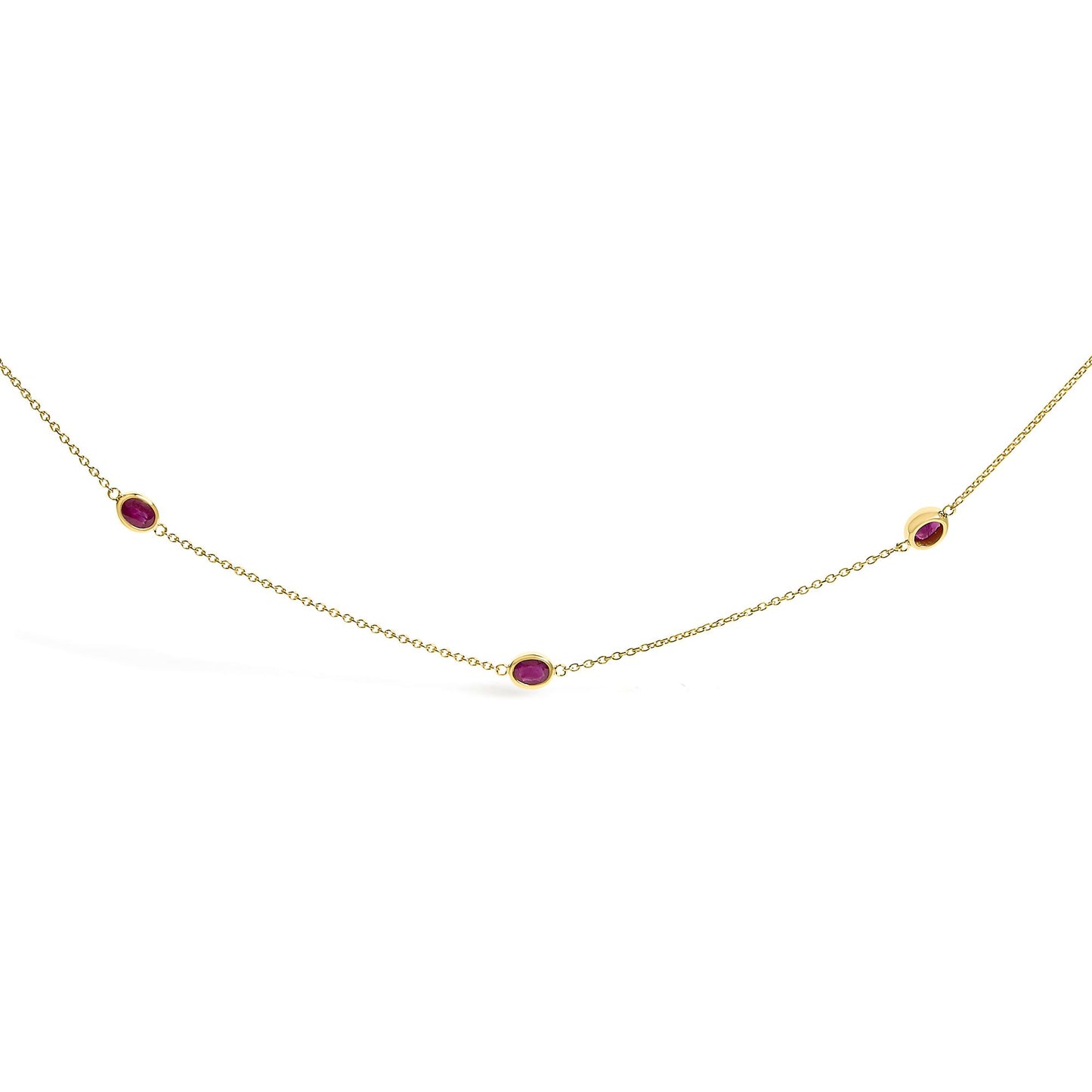 Yellow metal necklace shown in a front-facing angle with evenly spaced oval red gemstones in bezel settings along the chain.