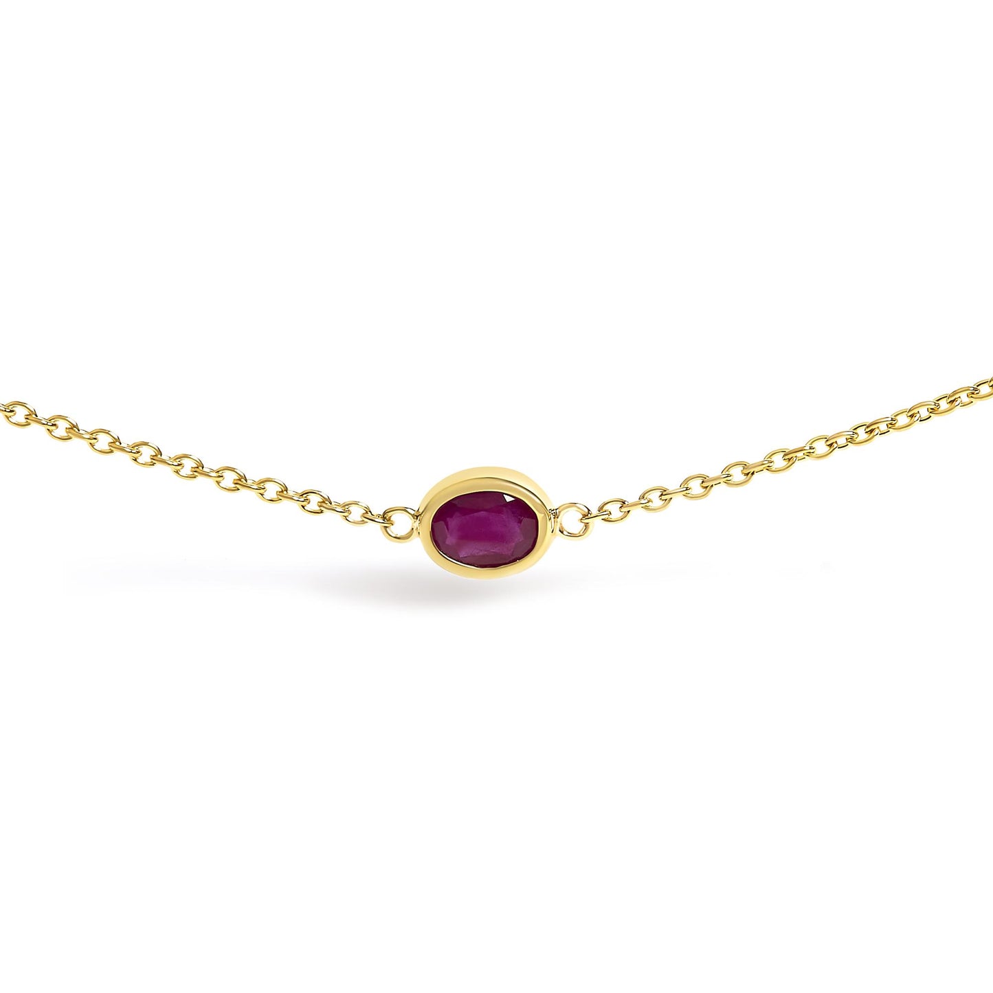 Close-up front angle of a yellow necklace with a single oval red gemstone in a bezel setting on a chain.