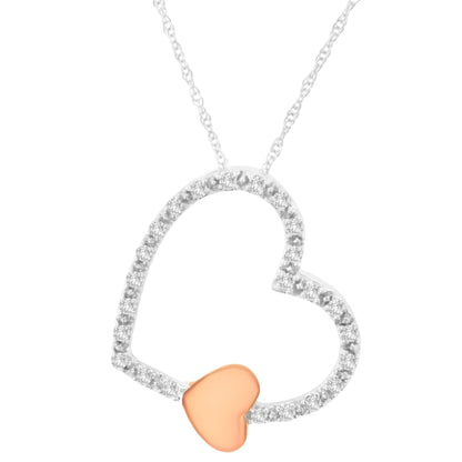 Close-up front view of a heart-shaped necklace pendant with a white metal open heart accented with small brownish round gemstones in a micro-pave setting, and a smaller solid rose-colored heart attached at the bottom.