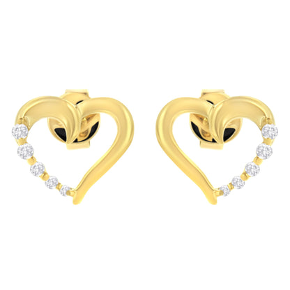 Pair of yellow metal heart-shaped earrings with a curve of small white gemstones along one side, shown from the front angle.