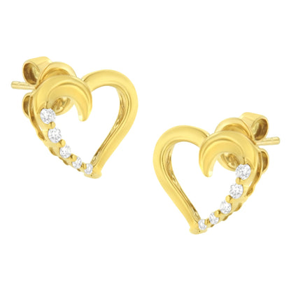 Pair of yellow earrings in heart shape with prong-set white gemstones along one side, shown from front angle.