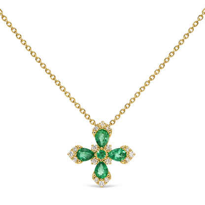 Close-up front view of a yellow necklace with a cross-shaped pendant featuring pear-shaped green gemstones surrounded by round white gemstones in prong settings.