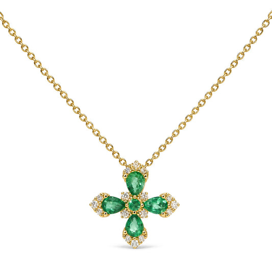 Close-up front view of a yellow necklace with a cross-shaped pendant featuring pear-shaped green gemstones surrounded by round white gemstones in prong settings.