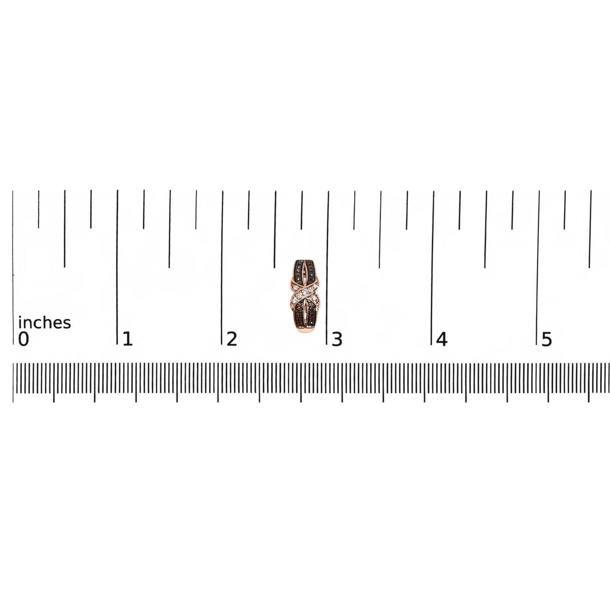 Close-up front view of single rose metal earring with white and brown gemstones in pave setting, placed on a ruler for size reference.